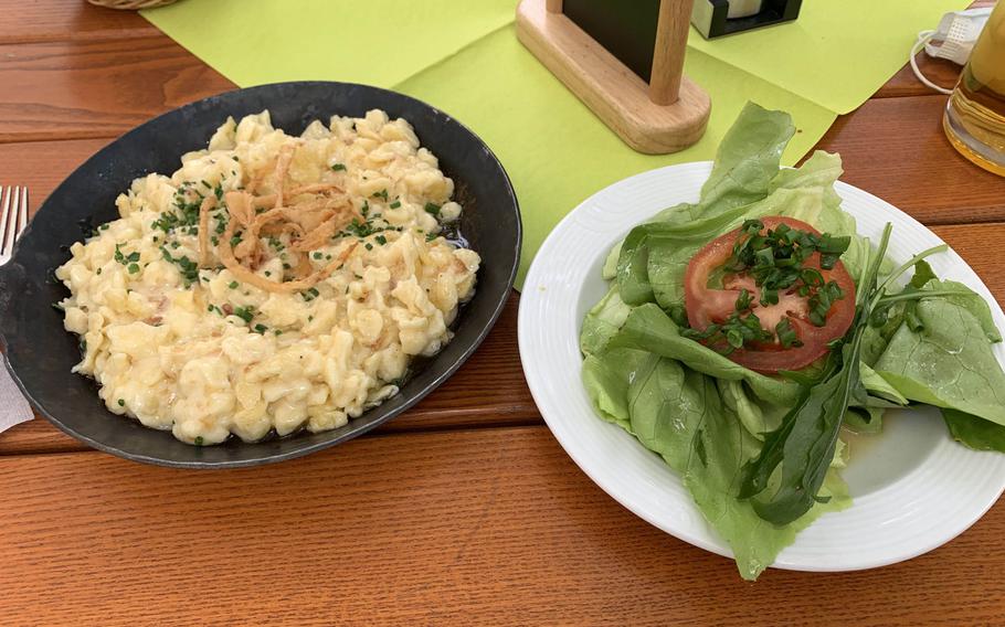 The spaetzle with cheese and onions served with a salad at the restaurant Zum Stich'n in Grafenwoehr, Germany on May 22, 2020.