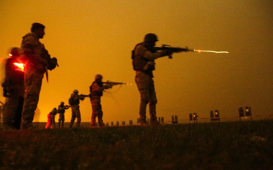 Iraqi soldiers from the 40th Brigade conduct a night live-fire exercise at the Besmaya Range Complex in Iraq on March 25, 2018. The U.S.-led coalition fighting the Islamic State group is handing over the range and about $5 million in equipment to the Iraqi military as international forces draw down their presence in the country.