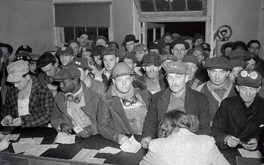Workers at the Hanford, Wash., Engineer Works send money home in this undated photograph.