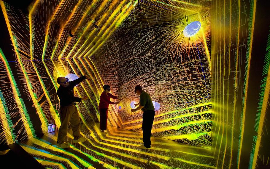 Researchers inspect an astronomical simulation at the Los Alamos SuperComputing Center on Nov. 29, 2006.