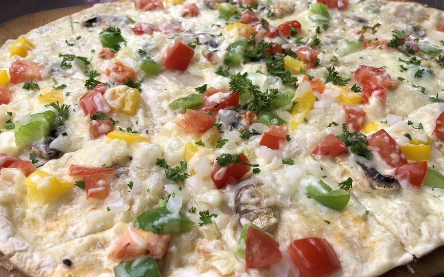 The vegetarian flammkuchen at Licht-Luft in Kaiserslautern was delicious. The Crispy crust is covered with tomatoes, peppers, cheese and onions.