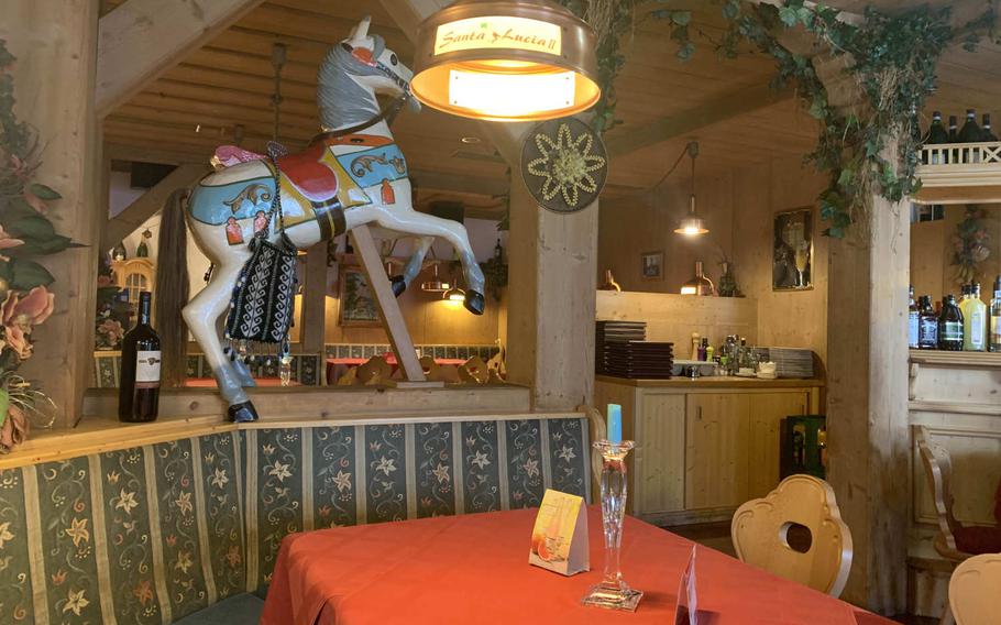 Pizzeria Santa Lucia II in Grafenwoehr, Germany, features colorful horses inside and and enough space for social distancing.