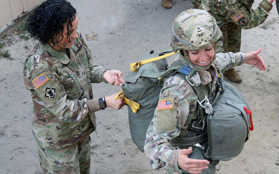 Master Sgt.Jessica Alicea-Cavezza conducts a jumpmaster inspection on Capt. Sara Roger, prior to an airborne operation at Camp Mackall, N. C. in March 2019. The Army is surveying women in the force to help pick the best sports bras on the market to go into the standard clothing bag issue.