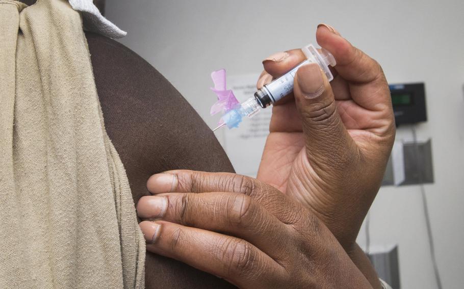 A medical technician gives an airman a flu shot at Joint Base McGuire-Dix-Lakehurst, N.J., in 2016. Some U.S. military installations in Europe will begin vaccinating active-duty personnel for influenza next week, but DOD personnel and families in Europe at many bases will have to wait until next month at the earliest for their flu jab.
