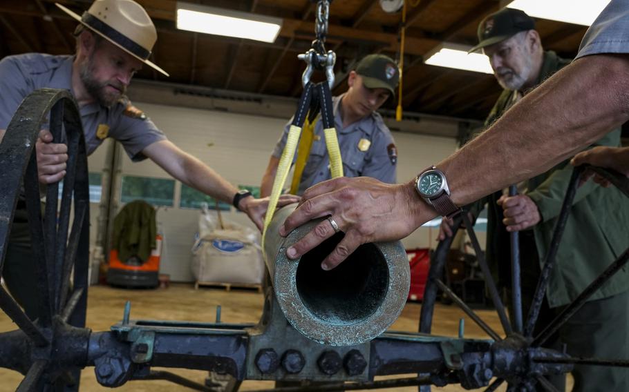 From left, Brandon Bies, Andrew Bentley, Jim Burgess and Jason Edwards, all with the National Park Service's Manassas National Battlefield Park, disassemble two Civil War cannons that were given to the Manassas battlefield.