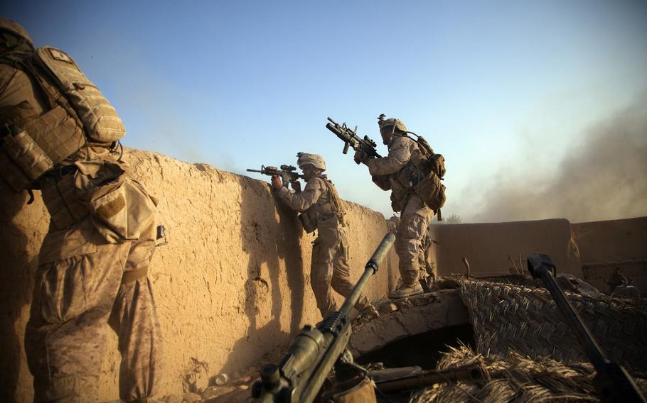 Marines from the 2nd Battalion 5th Marine Regiment return fire in Afghanistan after the enemy fired an RPG rocket at their position on July 15, 2012. 