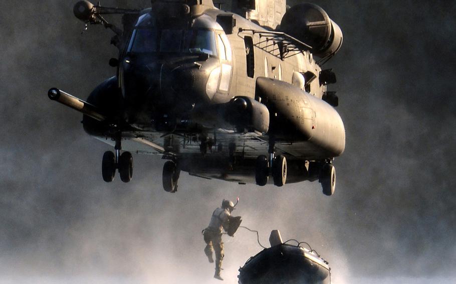 An airman jumps out of an MH-47 Chinook helicopter during insertion and extraction training with soldiers from the 160th Special Operations Aviation Regiment onJuly 14, 2014, at Joint Base Lewis-McChord, Wash.