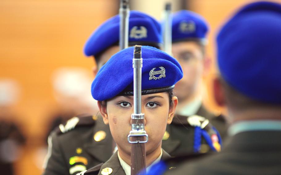 JROTC Cadet and Yokota High School Senior Iris Cruz performs successive drill movements during the armed regulation drill portion of the Far East Rife and Drill Competition at the Camp Foster Field House. 
