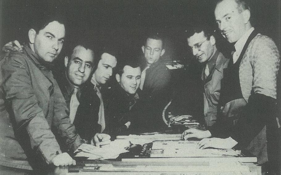 Image scanned from "Stars and Stripes, WWII & The Early Years" by Ken Zumwalt, former editor of Stars and Stripes Europe. Caption in book: NORTHERN IRELAND 1942: From left, Carl Larsen, Tony Cordaro, Bryce Burke, Maj. Harry Hatcher (officer in charge), Bert Marsh, Fred Ferrara, and unidentified Belfast telegraph printer. 