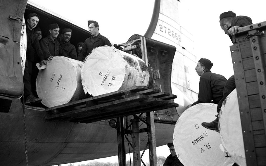 Wiesbaden, Germany, October, 1948: Rolls of newsprint are loaded on an airlift transport plane, bound for Berlin. One hundred tons of paper were being flown to the blockaded city by the Air Force every week, as allocated by Gen. Lucius Clay, to allow newspapers of the three Western sectors to combat the Soviet-controlled Berlin press. 