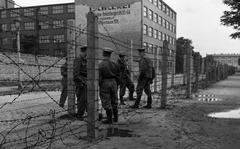 Barbed wire plays an important part in the East Zone Communists' scheme of things, as demonstrated by those Vops who are laying a strand at the border in Berlin 