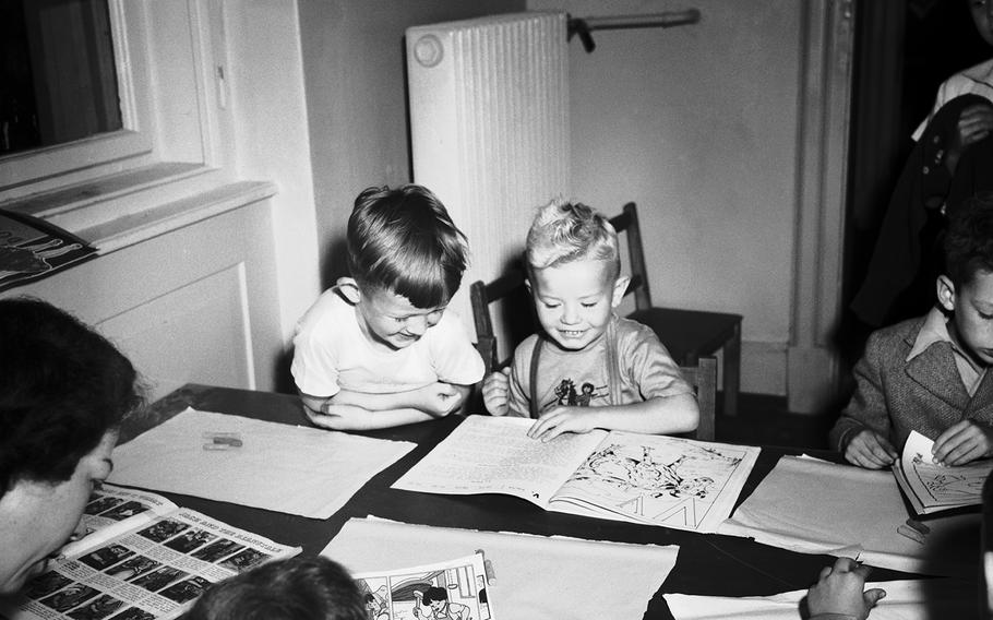 Johnny Walkmann, left, and Billy Feeman are old hands at picture books, even though it's only their first day in Kindergarten at the Heidelberg dependents' school, Sept. 8, 1948.
