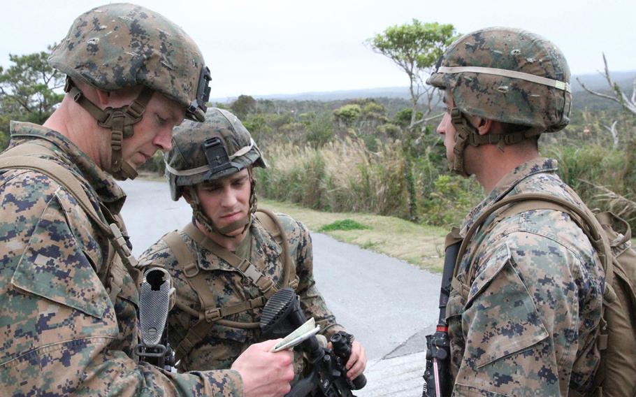 Then-Cpl. Donald Horn, now a sergeant, left, looks at his map during a land-navigation training exercise at the Jungle Warfare Training Center at Camp Gonsalves in OkinawaÕs remote north in March 2015.