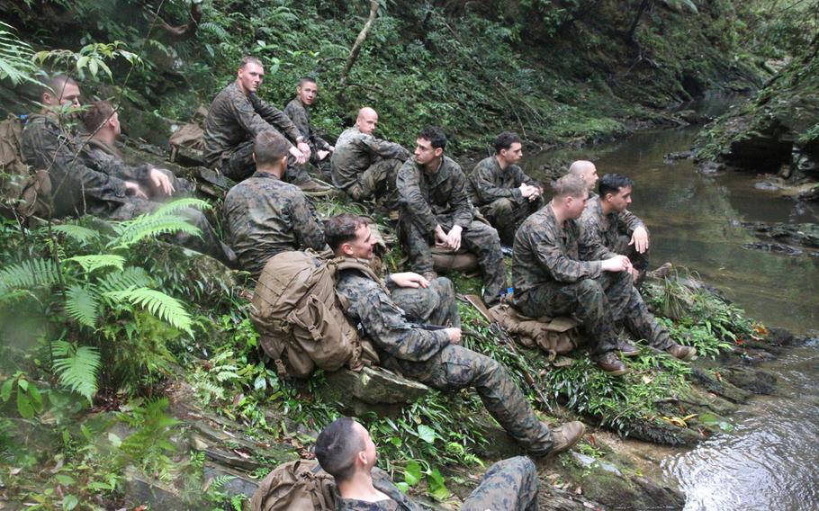 Company I Marines rest by a jungle stream during a break from jungle warfare training at the Jungle Warfare Training Center in northern Okinawa in March. The Marines came to Japan on a six-month rotation to learn to survive and fight in the jungle's harsh environment. 

