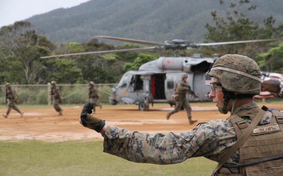 Cpl. Curtis Beam directs his squad during casualty evacuation drills using two MH-60S helicopters from Helicopter Sea Combat Squadron 12 at Okinawa's Jungle Warfare Training Center in March. 

