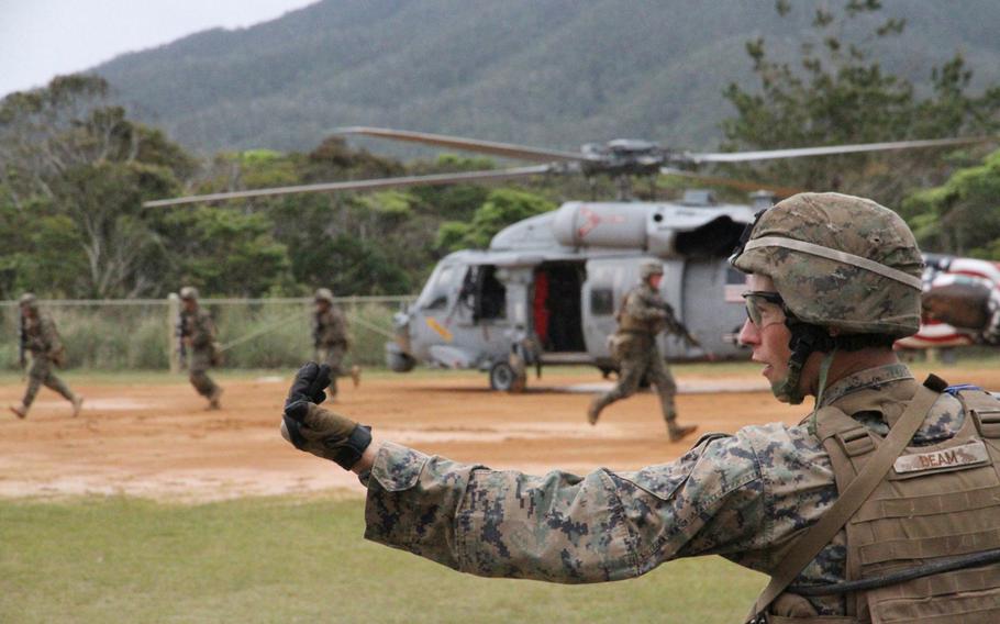 Cpl. Curtis Beam directs his squad during casualty evacuation drills using two MH-60S helicopters from Helicopter Sea Combat Squadron 12 at Okinawa's Jungle Warfare Training Center in March.