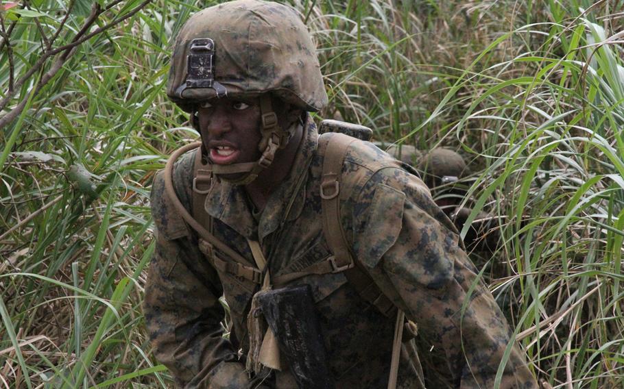 Lance Cpl. Khadeem Jeffers, a mortar man with Company I's weapons platoon, breaks through dense jungle foliage at the end of the arduous E-Course on Okinawa in March 2015.

