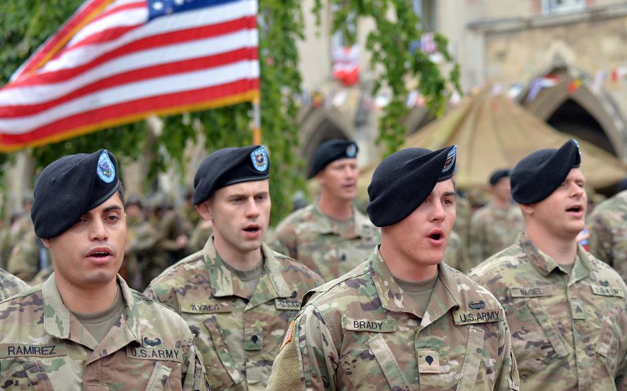 101st Airborne soldiers sing the Army song at the conclusion of a reenlistment ceremony for 21 soldiers of the division in Carentan, France, Friday, June 7, 2019.