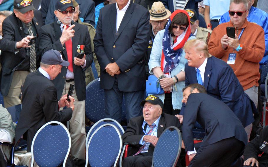 Presidents Donald Trump of the U.S. and France’s Emmanuel Macron pose with a World War II veteran during the 75th anniversary of D-Day ceremony at Normandy American Cemetery in Colleville-sur-Mer, France, June 6, 2019.