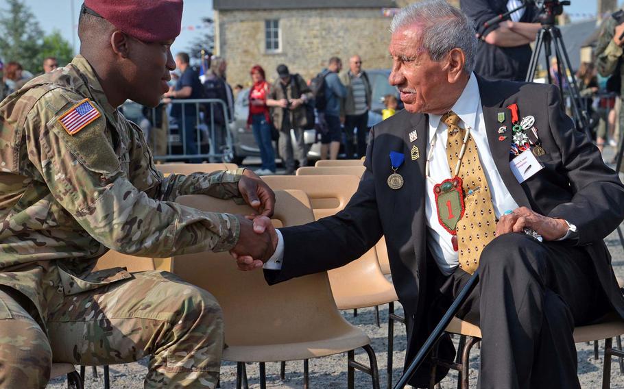 Pfc. Jonathan Stanley of the XVIII Airborne Corps talks to D-Day veteran Charles Shay before a ceremony honoring air crews and airborne troops at Picauville, France, Tuesday, June 4, 2019. It was one of many events this week marking the 75th anniversary of D-Day in World War II.