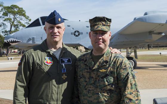 U.S. Air Force Maj. Jeremiah ‘Bull’ Parvin, 75th Fighter Squadron director of operations, and U.S. Marine Corps Master Gunnery Sgt. Richard Wells, senior enlisted advisor of Marine Special Operations School, pose for a photo Jan. 29, 2015, at Moody Air Force Base, Ga. Parvin received the Distinguished Flying Cross with Valor for his heroic actions that saved the lives of Wells’ team during a 2008 deployment to Afghanistan.