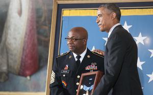 Command Sgt. Maj. Louis Wilson, the top enlisted soldier of the New York Army National Guard, receives the Medal of Honor on behalf of Army Private Henry Johnson, a veteran of World War I, who was awarded the nation's highest military honor posthumously at the White House on Tuesday, June 2, 2015, from President Barack Obama.