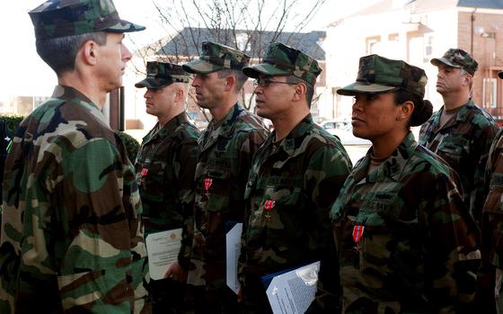 (from left to right) Chief Mass Communication Specialist Tom Jones, Mass Communication Specialist 1st Class Steven Harbour, Mass Communication Specialist 1st Class David Hoffman and Mass Communication Specialist 1st Class Jackey Bratt stand at attention after being awarded the Bronze Star Medal during an awards presentation ceremony at Naval Station Norfolk, Jan. 9, 2007. The Bronze Star Medal is awarded to distinguished service members for exceptional meritorious service while engaged in military operations involving conflict with an opposing foreign force. U.S.  