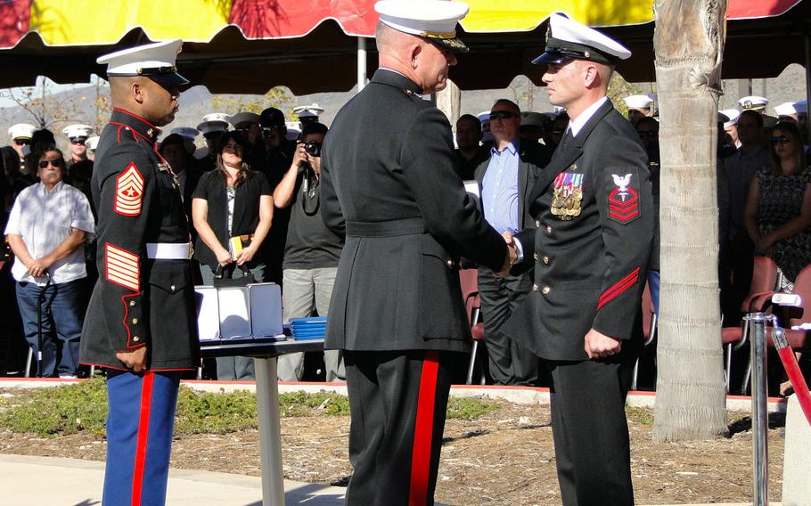 Maj. Gen. Joseph Osterman, commander of Marine Special Operations Command, presents a Navy Cross to Chief Petty Officer Justin Wilson on Tuesday at Camp Pendleton, California. Wilson is the first sailor in MARSOC history to receive the award. 