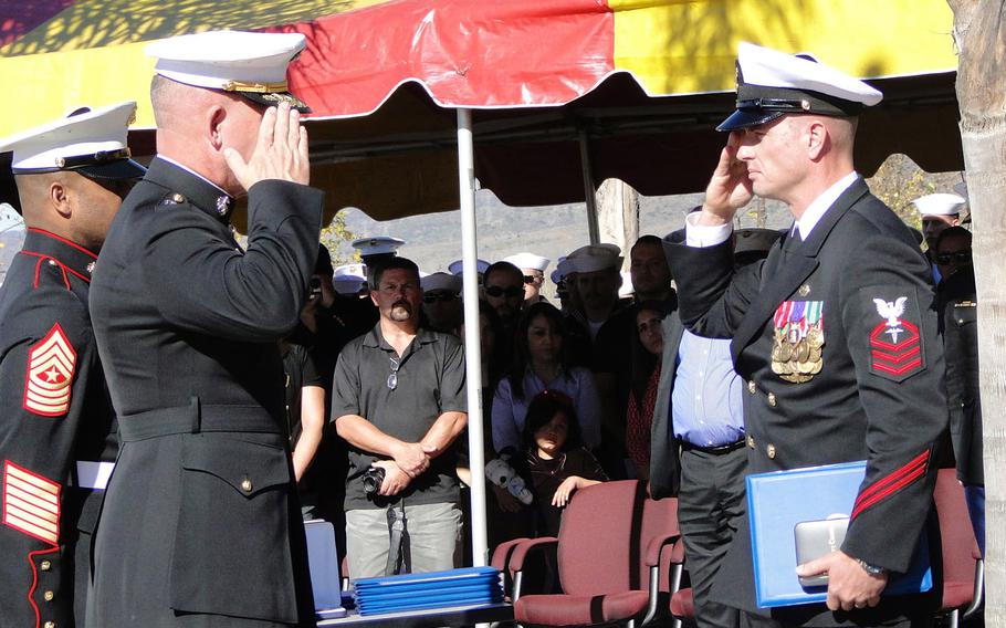 Maj. Gen. Joseph Osterman and Chief Petty Officer Justin Wilson salute one another after Osterman awarded the Navy Cross to Wilson on Tuesday at Camp Pendleton. Wilson earned the medal for his actions in Helmand province, Afghanistan, on Sept. 28, 2011. 
