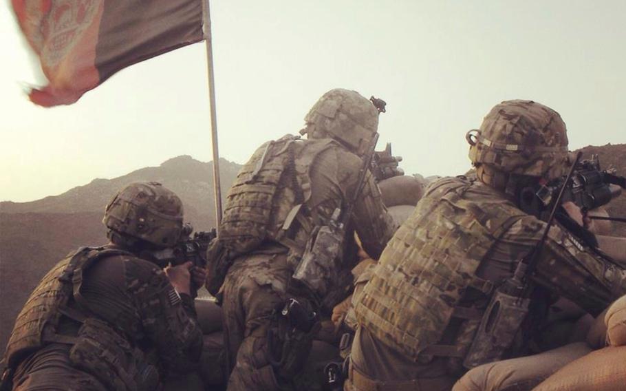 Sgt. Sean T. Ambriz, center, and other members of the 127th Military Police Company based at Fort Carson, Colo., scan for targets during their 2011 deployment to eastern Afghanistan.