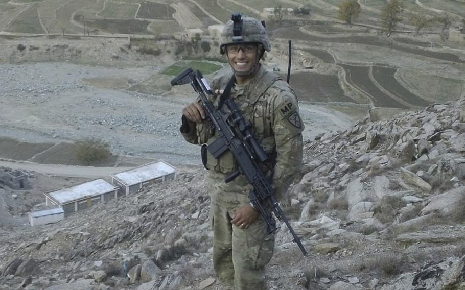 Sgt. Sean T. Ambriz, a member of the 127th Military Police Company based at Fort Carson, Colo., poses with a designated marksman rifle in the Pech River Valley in Afghanistan's Kunar province in 2011.  