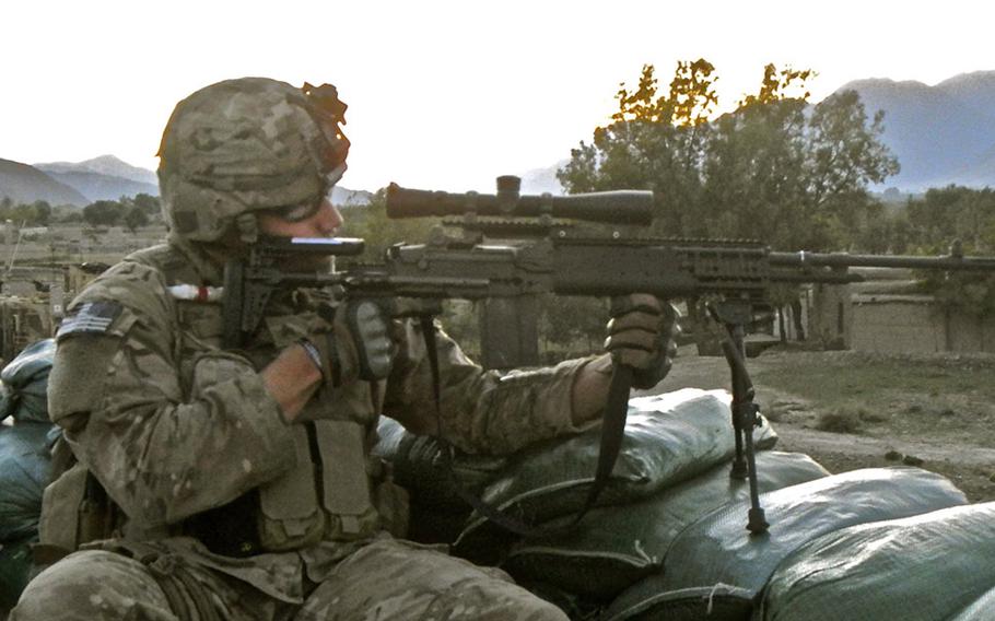 Sgt. Sean T. Ambriz takes aim with a designated marksman rifle in eastern Afghanistan.