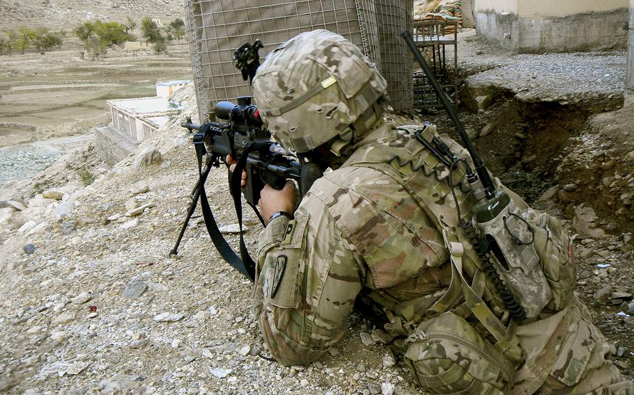 Sgt. Sean T. Ambriz takes aim with a designated marksman rifle in eastern Afghanistan.