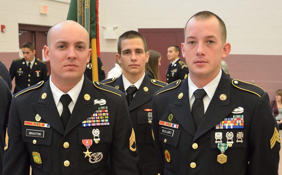 North Carolina National Guard Military Police Officers Army Staff Sgt. Andrew Braxton, left, and Army Sgt. Benjamin Bullard, right, after a ceremony held in their honor at the NCNG's 514th Military Police Company headquarters at Capt. Christopher Cash Armed Forces Reserve Center in Winterville, N.C., Dec. 7, 2014. Bullard was awarded the Army Commendation Medal and Braxton the Bronze Star, both with the "V" signifying that the medal was awarded for courage in battle in Afghanistan during an attack on Oct. 1, 2012 that killed three NCNG Soldiers and wounded three others. "They are heroes in our midst," said Army Col. Eric Kohl, commander of the NCNG's 130th Maneuver Enhancement Brigade, unit’s higher headquarters.