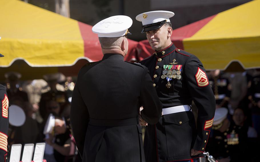 Marine Corps Maj. Gen. Joseph L. Osterman presents Gunnery Sgt. Brian C. Jacklin with the the Navy Cross Medal during a ceremony held to honor Jacklin and five other members of Marine Special Operations Team 8131 on April 9, 2015. On June 14, 2012, while deployed to Afghanistan, Team 8131 simultaneously conducted counterattacks against the enemy, established village stability and evacuated two Marine casualties in Upper Gereshk Valley of Helmand province.