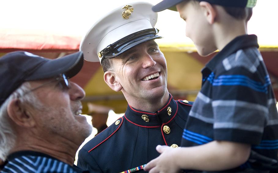 Gunnery Sgt. Brian Jacklin meets with his son, Hunter, 6, and his son's grandfather, Jim Klocke of Placentia, before a ceremony to award Jacklin with the Navy Cross at Camp Pendleton.