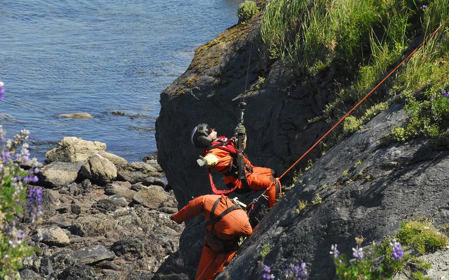AST2 Jonathan Kreske conducts cliff ops training on Kodiak Island, Alaska. Air Station Kodiak aircrews often train for these rescues to stay proficient in the event they are needed to rescue someone from a cliff side.