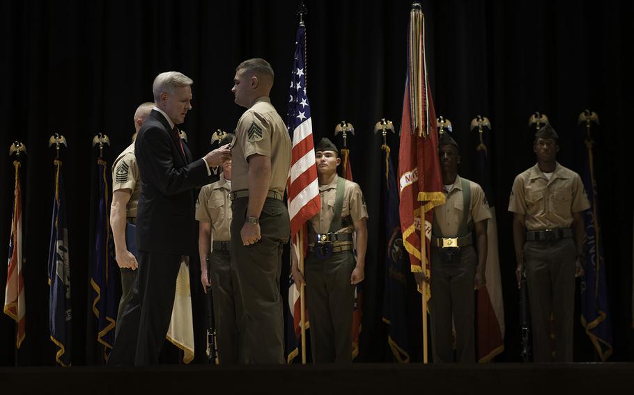 Secretary of the Navy Ray Mabus presents Sgt. Joshua Moore, assigned to 2nd Battalion, 8th Marines, with a Navy Cross medal on Nov. 1, 2013. Moore earned the award for his heroism during combat operations in 2011 while deployed to Marjah, in Afghanistan's Helmand province.