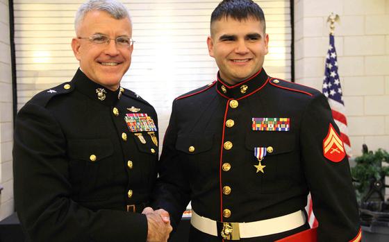 Cpl. Ethan Nagel, a Prior Lake, Minn. native, shakes hands with Brigadier General James S. Hartsell, commanding general of the 4th Marine Division, after having received the Silver Star, Dec. 17, for his actions in Afghanistan.