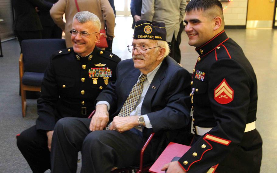 Cpl. Ethan Nagel, a Prior Lake, Minn. native, poses for a photo with his grandfather, retired Marine and Korean War veteran Richard Allen, and Brigadier General James S. Hartsell, commanding general of the 4th Marine Division, during Nagel's award ceremony after having recieved the Silver Star, Dec. 17.
