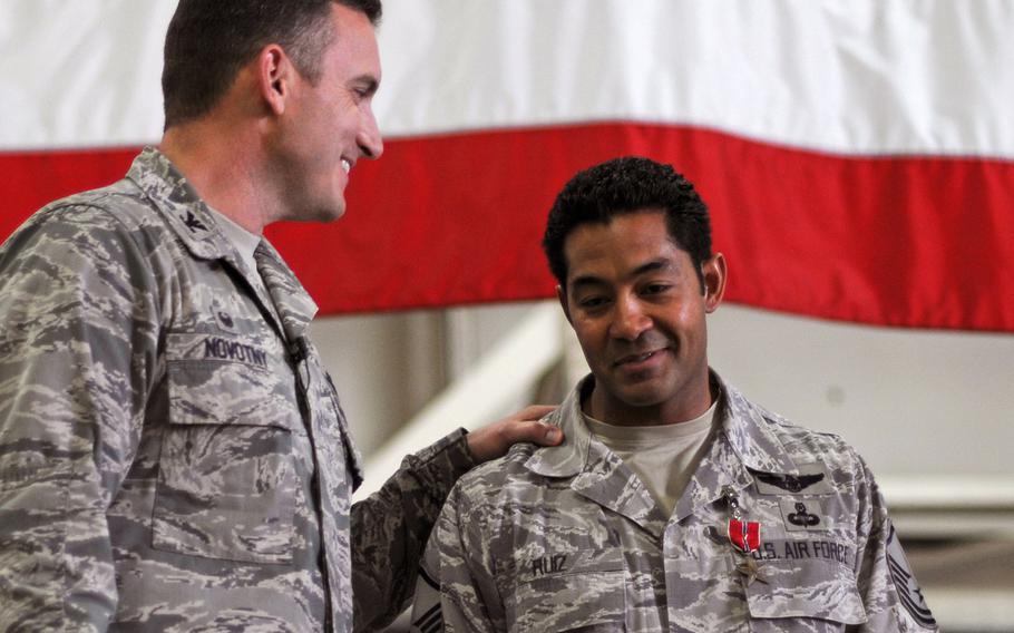 Col. Robert Novotny, 48th Fighter Wing commander, congratulates Master Sgt. Ivan Ruiz, 56th Rescue Squadron pararescueman, after presenting the Bronze Star Medal for Heroism at Royal Air Force Lakenheath, England, Oct. 27, 2014. Ruiz was awarded the medal for his courageous acts of heroism involving engagement in action against enemy forces in Afghanistan in September 2013.