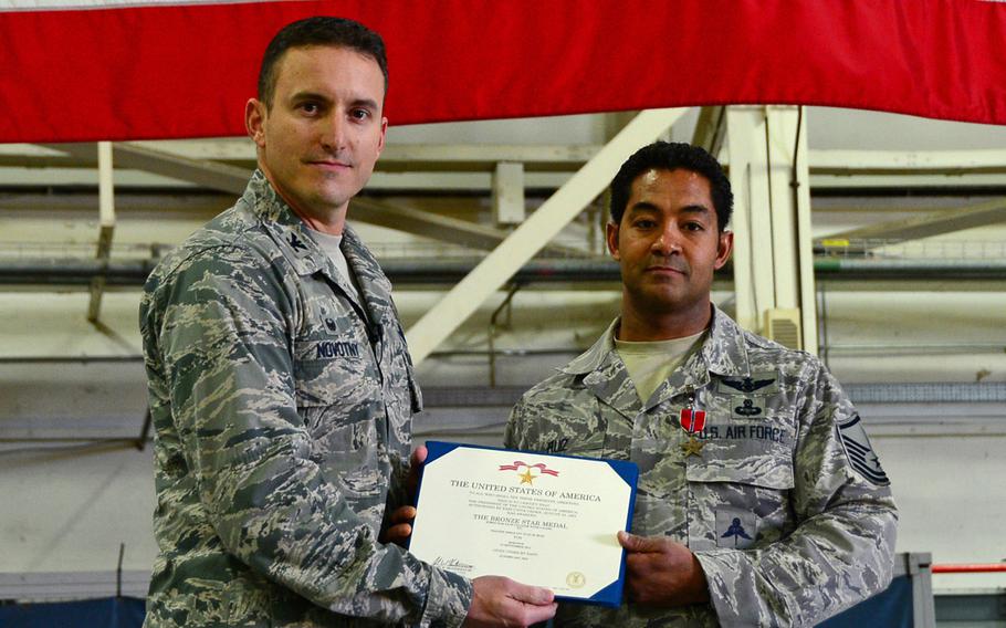 Col. Robert Novotny, 48th Fighter Wing commander, presents the Bronze Star Medal for Heroism to Master Sgt. Ivan Ruiz, 56th Rescue Squadron pararescueman, before a commander's call at Royal Air Force Lakenheath, England, Oct. 27, 2014. Ruiz was awarded the medal for his courageous acts of heroism involving engagement in action against enemy forces in Afghanistan in September 2013.