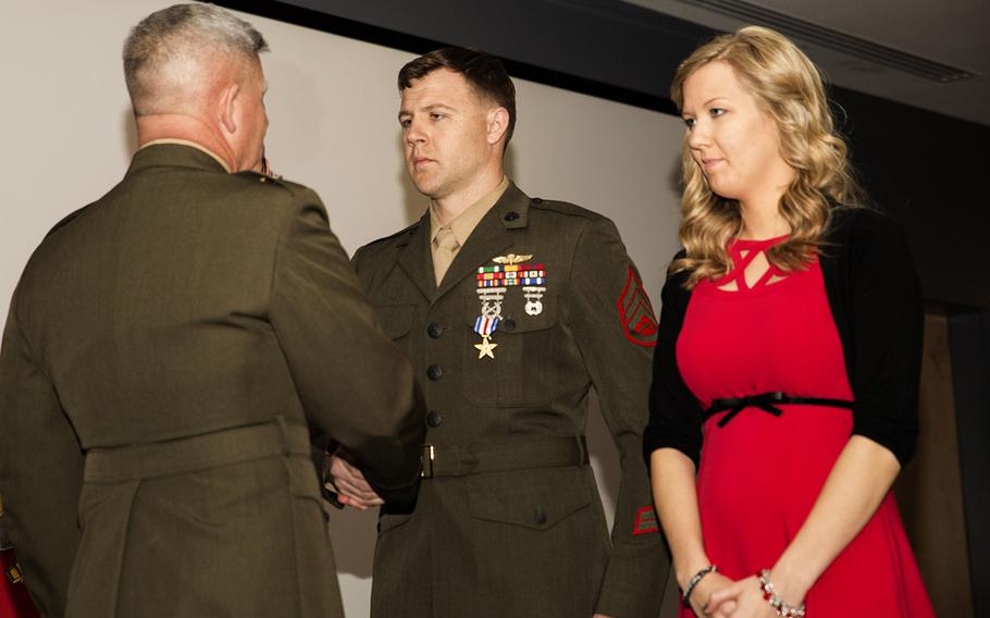Major Gen. Joseph L. Osterman, commander, U.S. Marine Corps Forces, Special Operations Command, awards Staff Sgt. Andrew C. Seif, a critical skills operator with 2nd Marine Special Operations Battalion, the Silver Star Medal during a ceremony at Stone Bay aboard Marine Corps Base Camp Lejeune, N.C., March 6, 2015. Seif, who was accompanied at the ceremony by his wife, Dawn, was awarded for his actions against the enemy in Badghis Province, Afghanistan, where he faced persistent enemy fire while rendering immediate aid to his mortally wounded teammate and completing their mission.