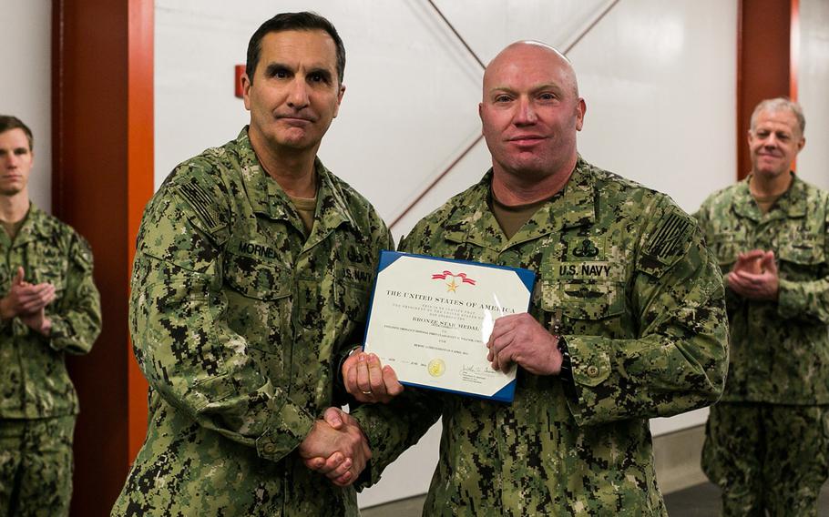 EOD technician Petty Officer 1st Class Scott Weaver is awarded the Bronze Star with Valor by head of Navy Expeditionary Combat Command Rear Adm. Frank A. Morneau during a ceremony at Joint Expeditionary Base Little Creek-Fort Story on Jan. 12. Weaver helped save the life of his SEAL team leader during an attack in southern Afghanistan in April 2012.