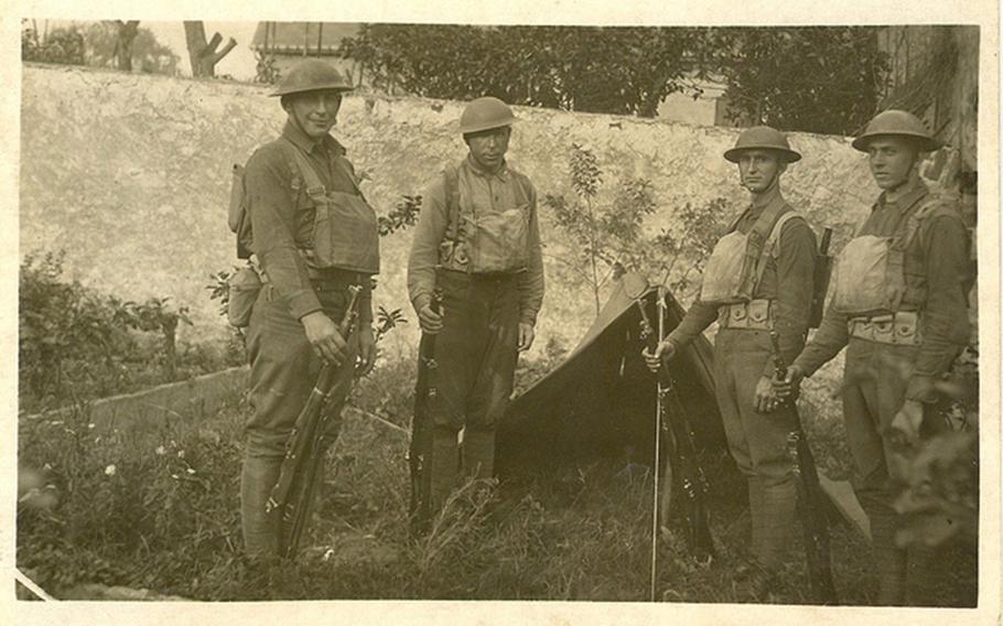 Photo of Sgt. William Shemin (far left) and three Soldiers in front of pup tent.