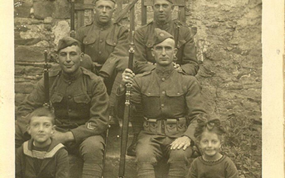 Photo of Sgt. William Shemin (front row, left) sitting on steps.