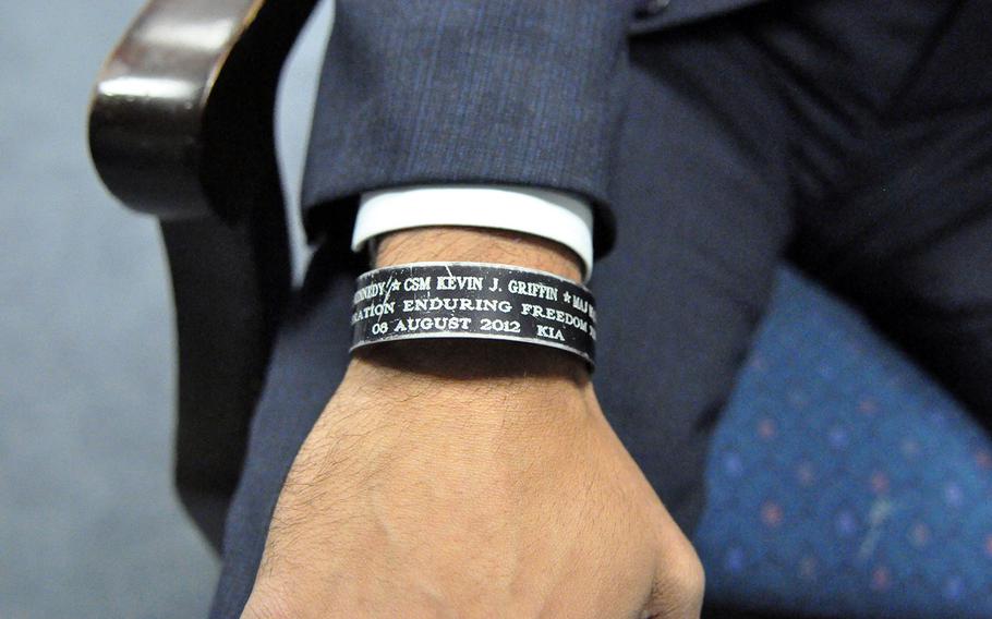 Capt. Florent Groberg displays his wristband that commemorates servicemen who were killed by an Afghan suicide bomber. They include Command Sgt. Maj. Kevin Griffin, of the 4th BCT, Air Force Maj. Walter David Gray,  Army Maj. Thomas Kennedy and Ragaei Abdelfattah, a USAID foreign-service officer. 