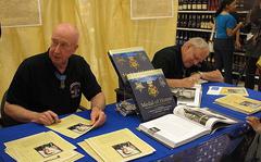 Medal of Honor recipients Don Jenkins, left, and Ken Stumpf, right, sign autographs at the Yokosuka Navy Exchange on Saturday. Each man received the award after saving the lives of their comrades during the Vietnam War. 