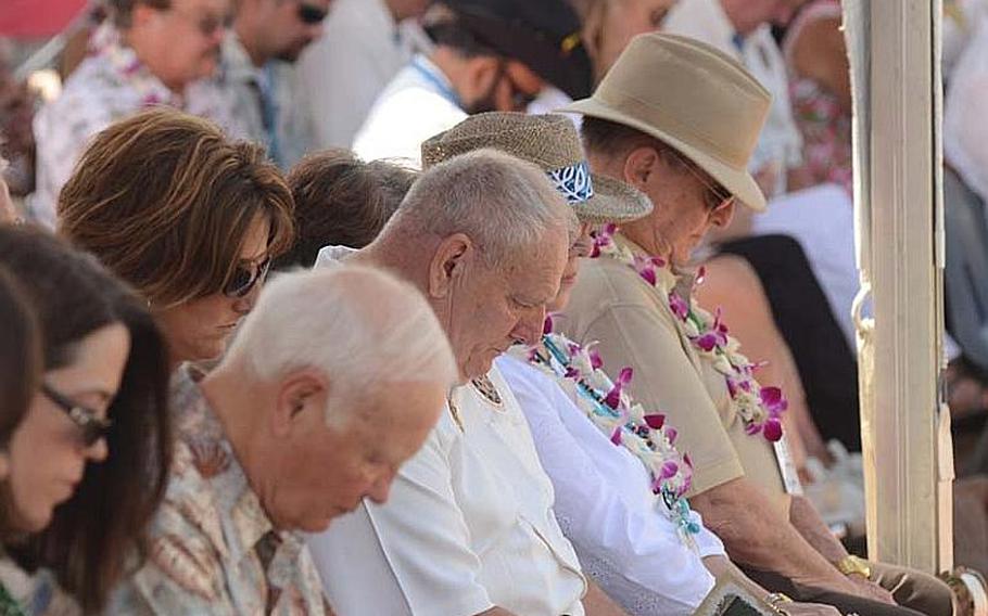 Medal of Honor recipient Kenneth Stumpf, center, bows his head in prayer along with other spectators at the National Cemetery of the Pacific in Honolulu on Oct. 3, 2012.  Stumpf and 51 other Medal of Honor recipients -- more than anyone present could remember gathering in one place -- honored past medal recipients buried at the cemetery with a stone memorial dedication.
