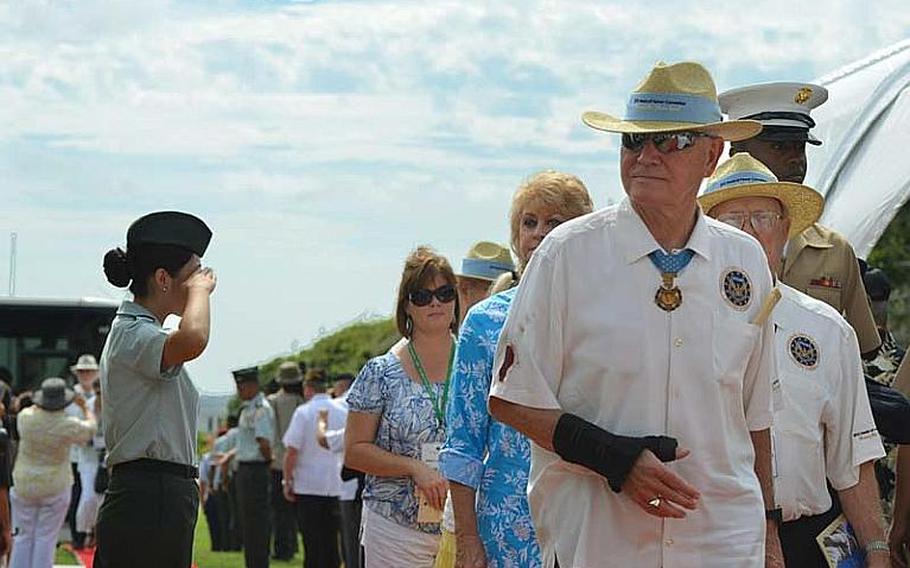 Medal of Honor recipient Leo Thorsness walks down a red carpet at the National Cemetery of the Pacific in Honolulu on Oct. 3, 2012. Thorsness and 51 other Medal of Honor recipients -- more than anyone present could remember gathering in one place -- honored the medal recipients buried at the cemetery with a stone memorial dedication.